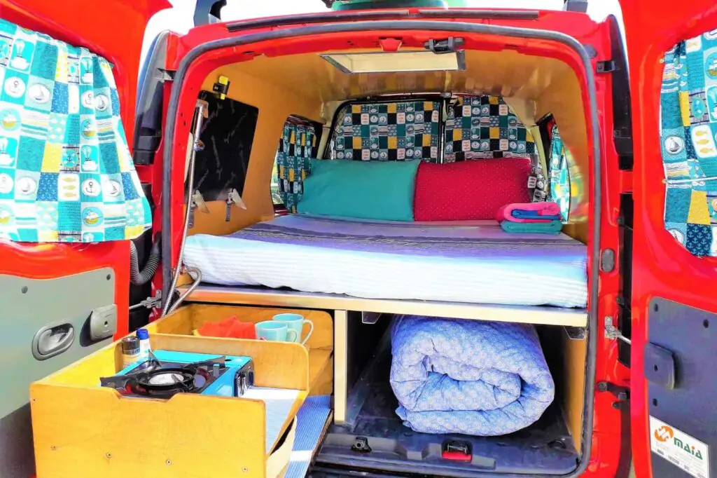 Ein „Atlantic“-Campervan, der mit geöffneter Heckklappe auf einem Küstenweg geparkt ist