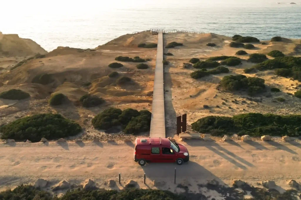 Mini campervan rental Faro exploring the Algarve coast at sunset