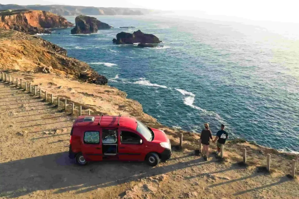 Mini campervan rental in Portugal overlooking the Atlantic coast cliffs