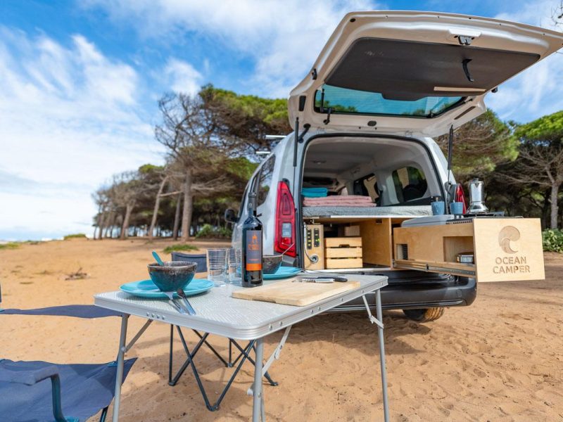 Mini campervan Portugal with outdoor kitchen setup on a sandy beach