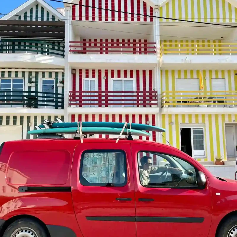 Campervan rental in Lisbon with mini campervan and surfboards near the Atlantic coast